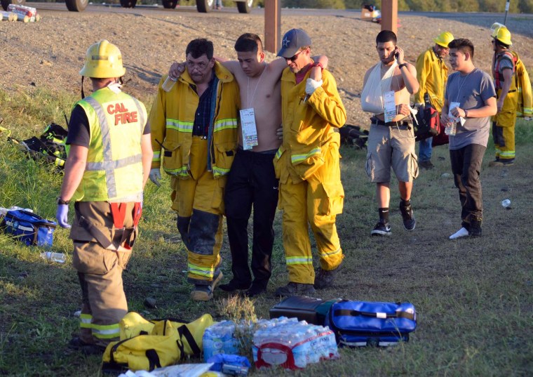 Image: Emergency personnel help a survivor of a wreck at the scene of a traffic collision on Interstate 5 near Highway 32 near Orland, California