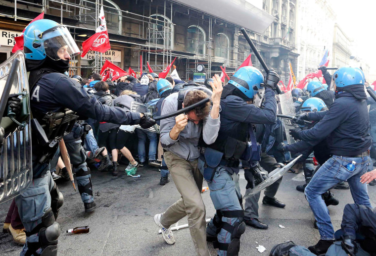 Image: Demonstrators fight with policemen during a protest in downtown Rome
