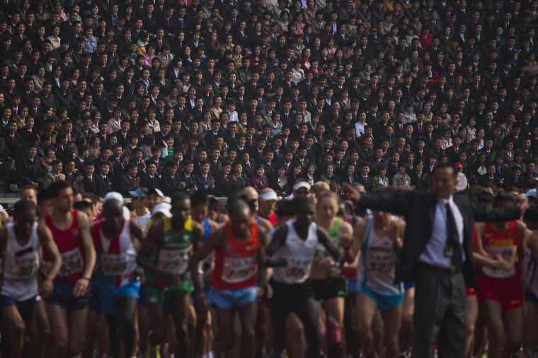 Image: North Korean spectators watch from the stands of Kim Il Sung Stadium as runners line up a the start of the Mangyongdae Prize International Marathon in Pyongyang