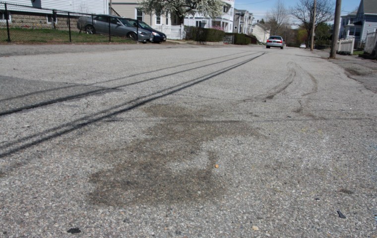 Image: A stain left on the street following the Boston marathon bombing suspect shootout