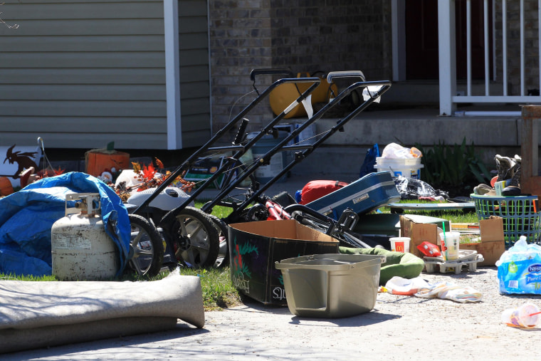 Belongings are shown on the ground in front of the garage where seven infant bodies were discovered and packaged in separate containers at a home in Pleasant Grove, Utah.