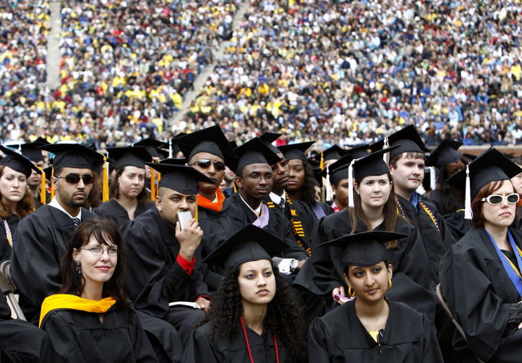 Image: Graduating students listen to U.S. President Obama speak during commencement at the University of Michigan