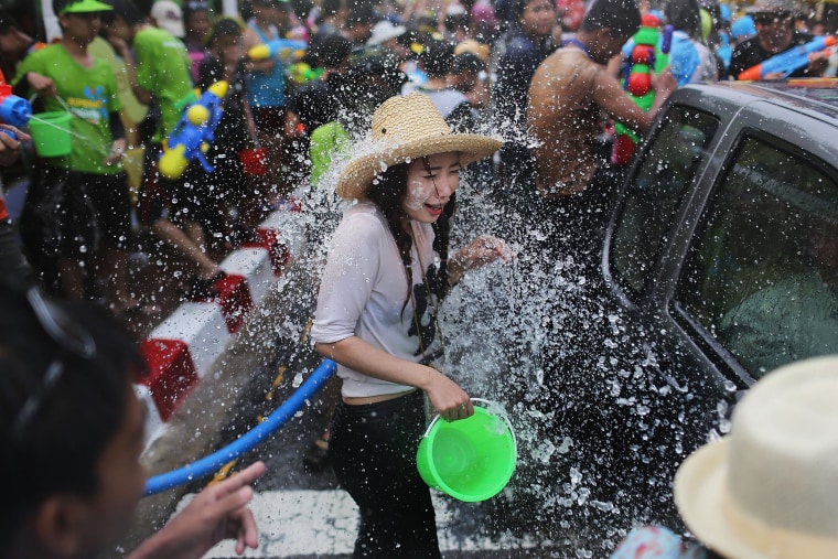 Image: Tourists and Thai residents take part in a city-wide water fight during the Songkran water festival