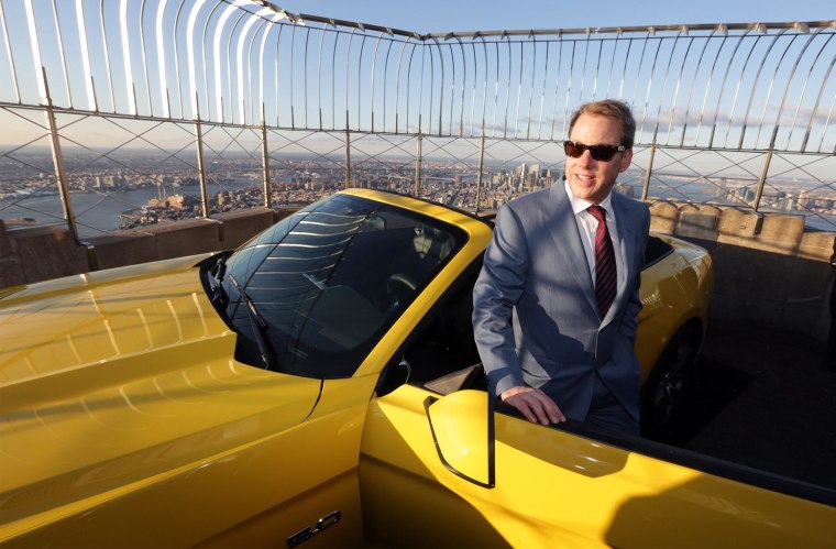Image: Ford Motor Company Executive Chairman Bill Ford poses next to a fully assembled 2015 Mustang convertible on display after an unveiling to honor 50 years of the Ford Mustang at the Empire State Building