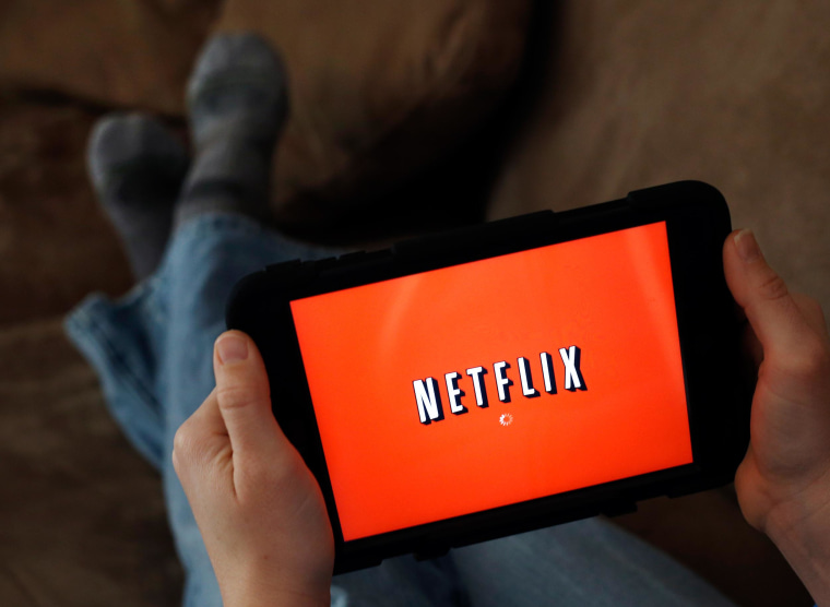 Image: A person displays Netflix on a tablet