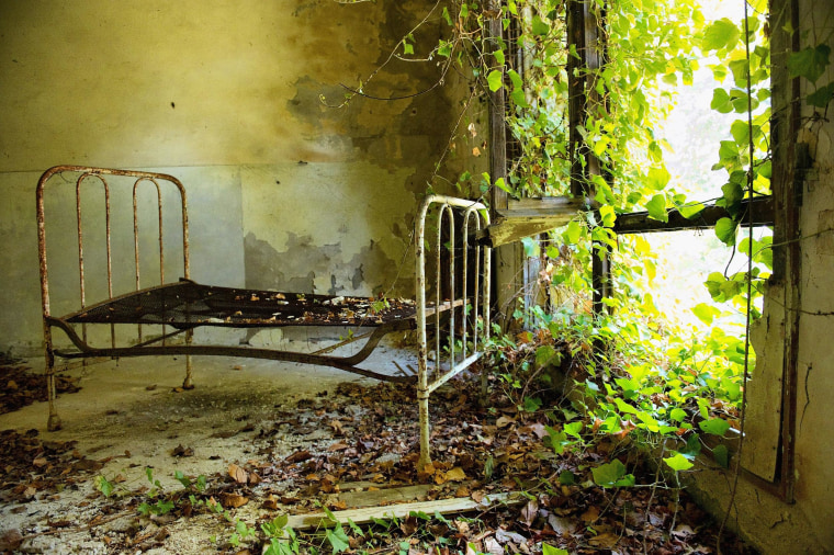A bed remains in one of the dormitories in the psychiatric ward of the abandoned Hospital of Poveglia on Aug. 27, 2011, in Venice, Italy. The island of Poveglia, with its ruined hospital and plague burial grounds, is said to be the most haunted location in the world. The area is located within a multimillion-dollar piece of real estate but is deserted and off limits to the public. The dark and derelict forbidding shores are only minutes away from the glamour of the Venice Film Festival on the Lido.
