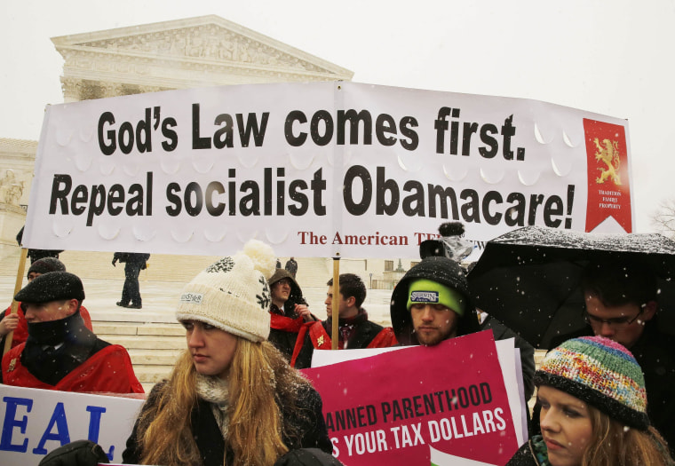 Image: Protesters rally at the steps of the Supreme Court in Washington as arguments begin today to challenge a part of the Affordable Care Act in Washington