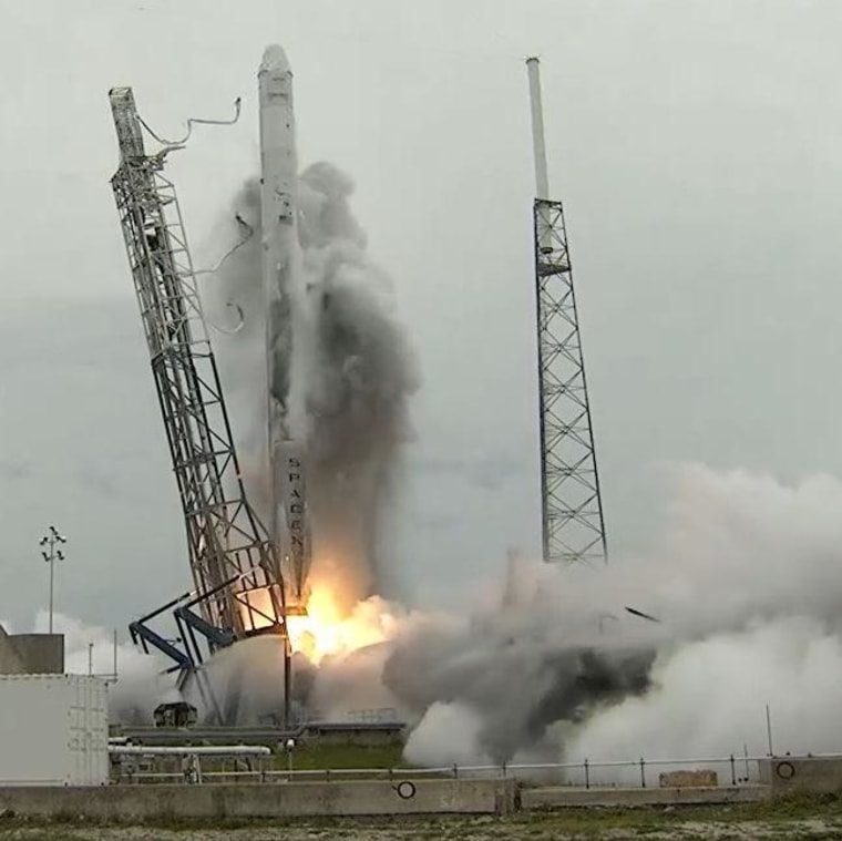 A dark plume sprays up the side of SpaceX's Falcon 9 rocket during Friday's launch, leaving a black stain behind. SpaceX CEO Elon Musk said the stain came from dirty water that had been spread over the Cape Canaveral pad before liftoff.