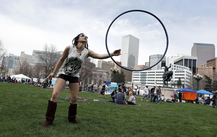 Image: Vanessa Vitali plays with a hoop at the annual 4/20 marijuana festival near downtown Denver at Civic Center Park