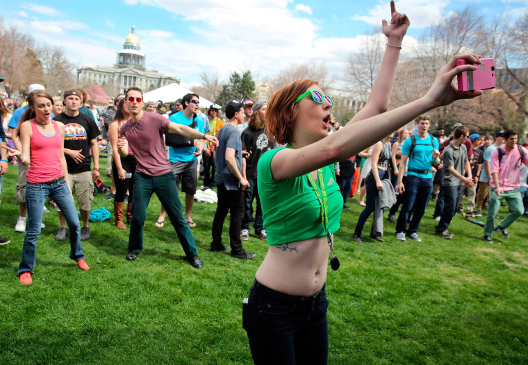 Image: Party goers dance at the annual 4/20 marijuana festival near downtown Denver at Civic Center Park