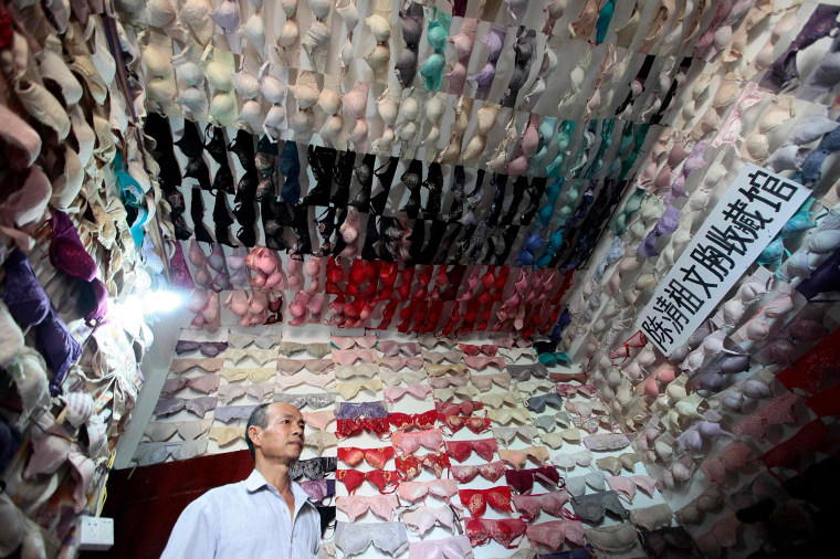 Chen Qingzu stands in a room where he displays his collection of bras, in Sanya, Hainan province, on April 22, 2014.