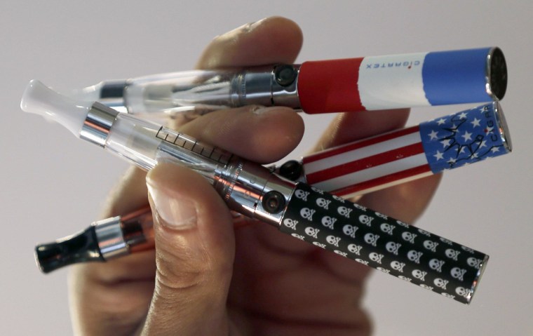 Image: A salesman displays electronic cigarettes