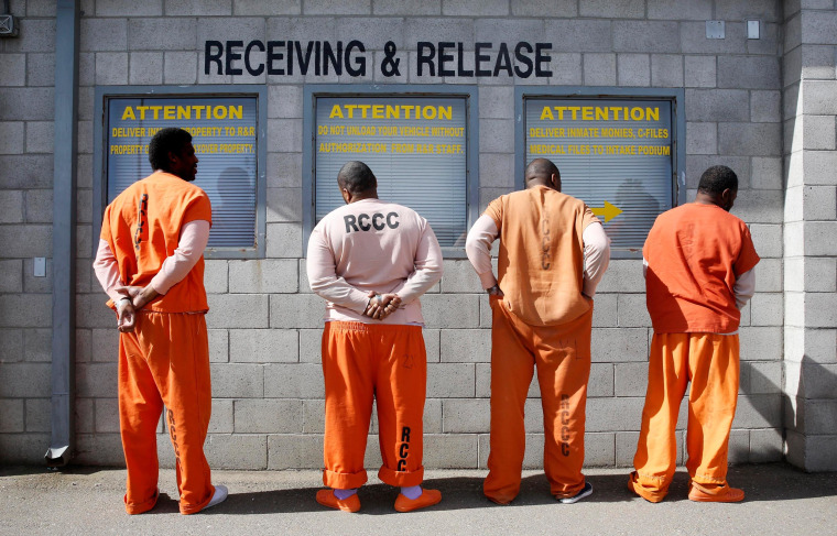 Image: Prisoners from Sacramento County await processing after arriving at the Deuel Vocational Institution in Tracy, Calif.