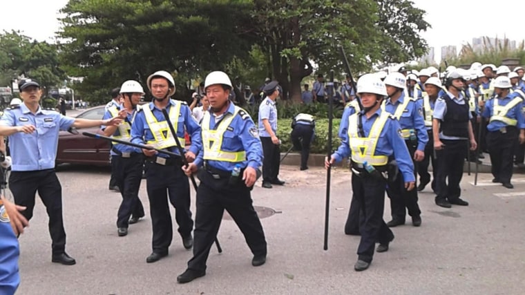 Police patrol as workers go on strike outside the Yue Yuen Industrial factory in Dongguan, China, on April 15.