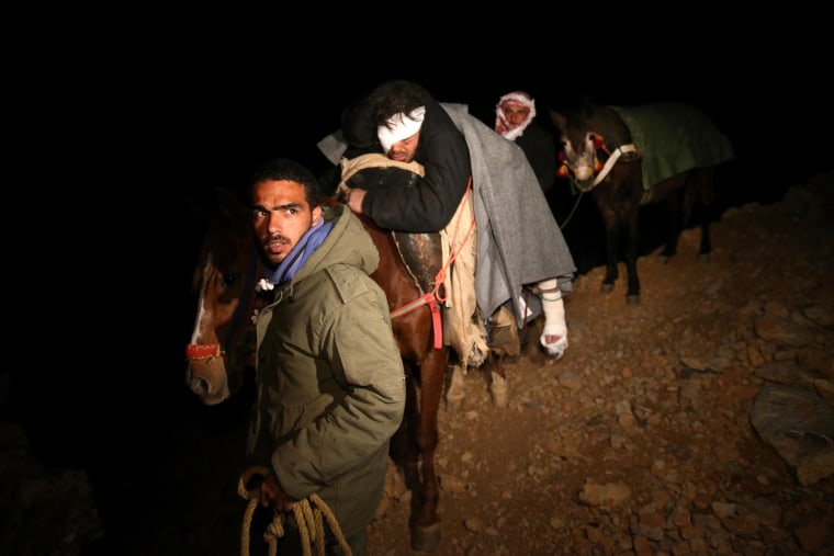 Saleh Zawaraa, 28, center, arrives on horseback into the town of Chebaa in southeast Lebanon after crossing Mount Hermon from Syria on April 20, 2014. Zawaraa was severely injured by a tank shell as he tried to bring bread into the village of Beit Jinn, which has been under siege by Syrian troops for months. No food or medicine has been allowed to reach thousands of civilians trapped there.