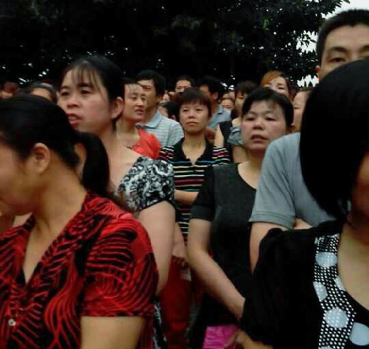 Striking workers gather outside the Yue Yen factory in Dongguan, China, on April 22.