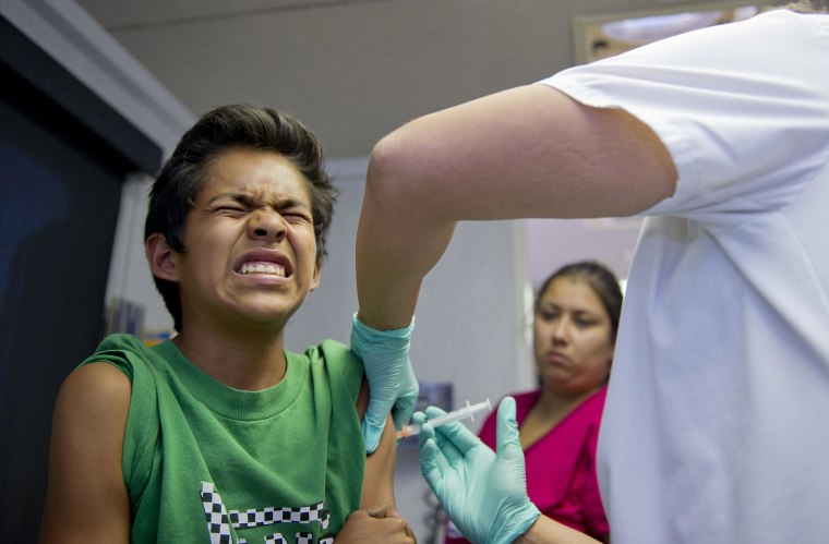 Image: A boy receives an immunization for the measles in California.