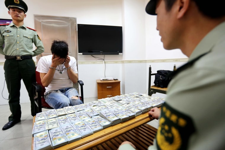 Man straps dollar banknotes to legs seized in Shenzhen