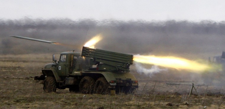 Image: A Russian BM-21 Grad multiple launch rocket system launches rockets during military exercises