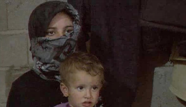 Syrian mother Um Mohammed, who is seven months pregnant, with one of her children.