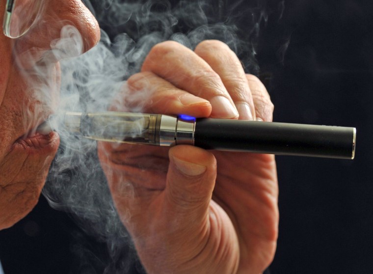 A smoker puffs on an e-cigarette.