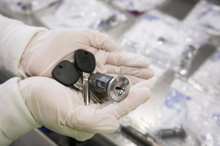 An employee holds General Motors ignition assembly parts, including the parts affected under the recalls, as they are being inspected, packaged and shipped.