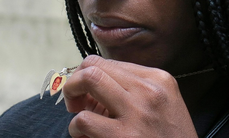 Image: Tarshia Williams displays a pendant with her daughter's face on it