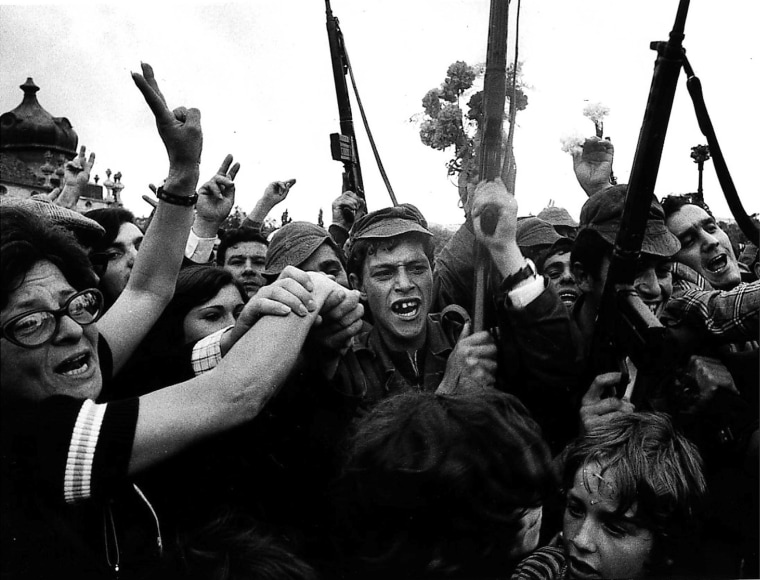 Image: Soldiers and civilians celebrate the victory of the Portuguese military uprising with carnations on April 25, 1974.