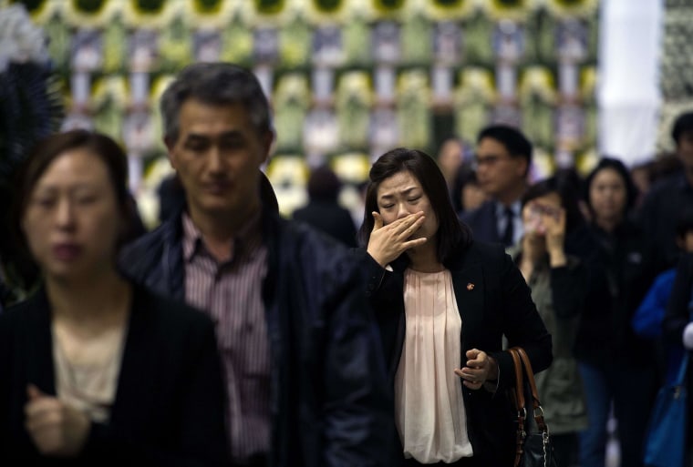 Image: Mourners attend a memorial for victims of the sunken South Korean ferry Sewol in Ansan