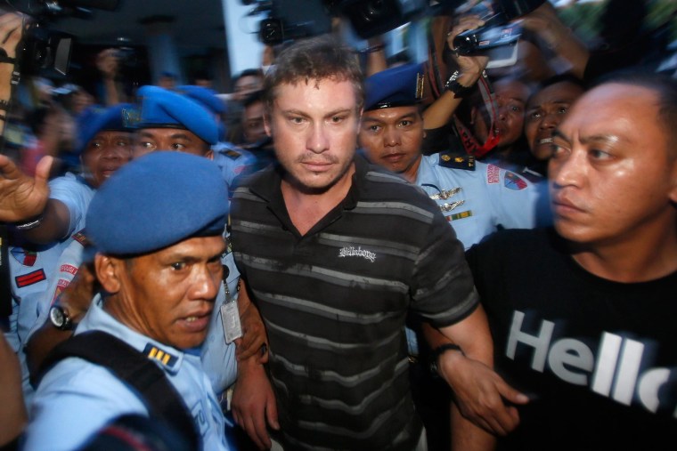 Image: Australian Matt Christopher Lockley is led away by Indonesian military officers