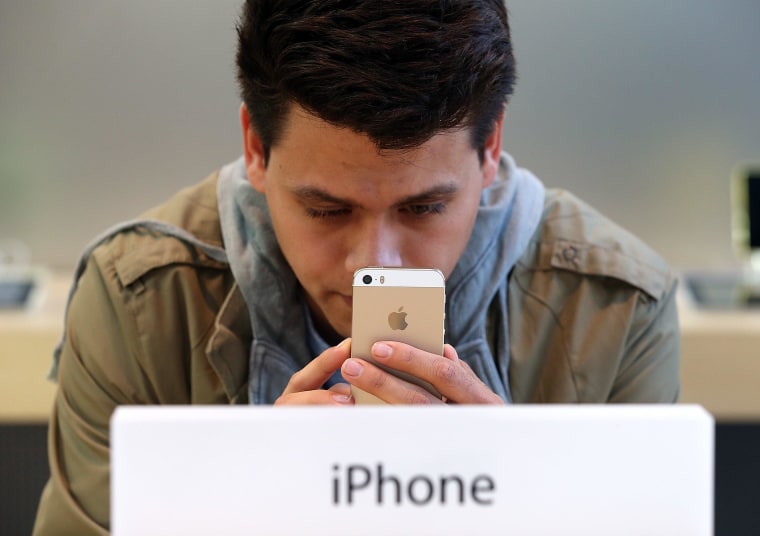 Image: Man looks at iPhone