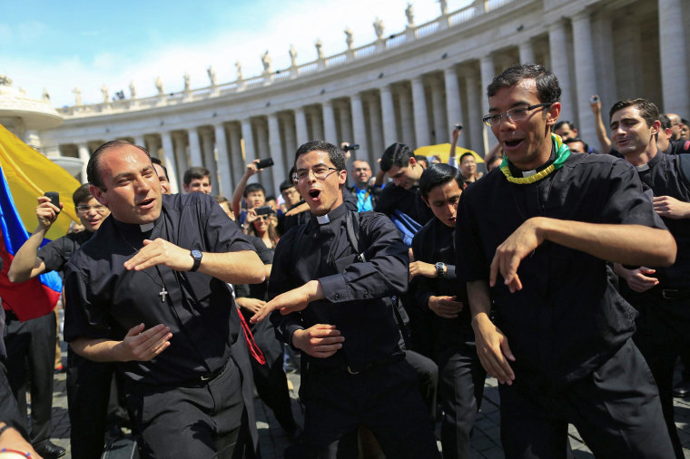 Image: Priests sing and dance in Saint Peter's Square at the Vatican