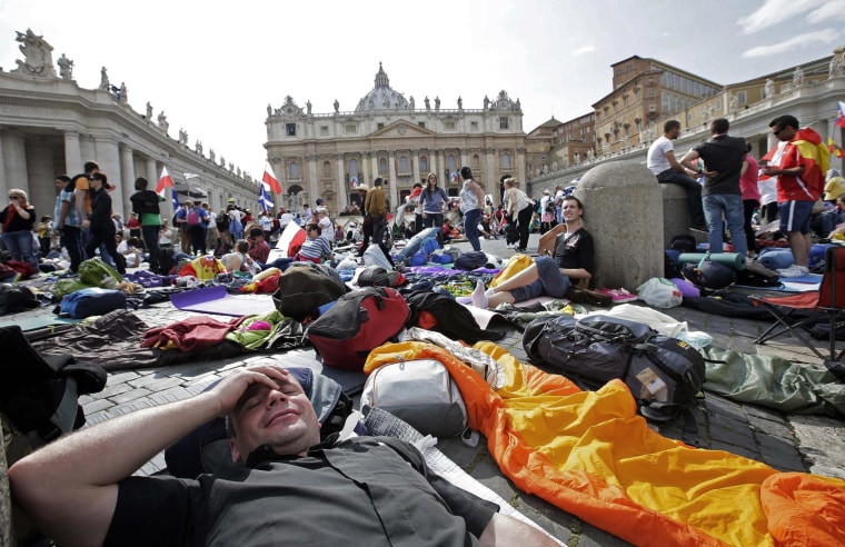Faithfuls wait in St. Peter's Square at the Vatican on Saturday.