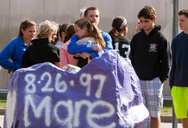 Image: Students mourn in front of Jonathan Law High School in Milford