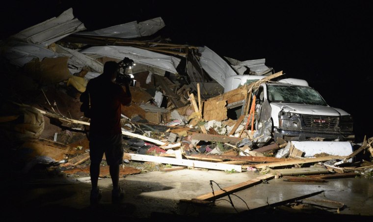 Image: First In Video news video photographer Brad Mack covers the damage seen after a tornado hit the town of Mayflower, Arkansas