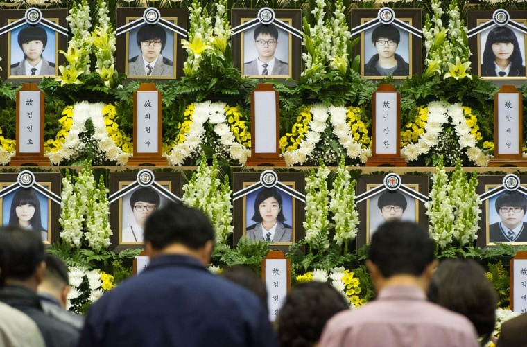 Image: People attend a memorial for the victims of the sunken South Korean ferry Sewol