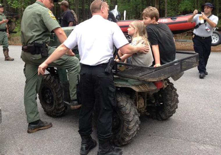 Officials speak with Jade and Dakota Kimbler Tuesday morning after they were rescued in Congaree National Park.