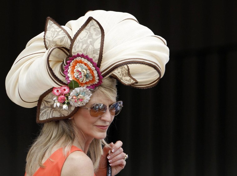 Image: A woman wears a fancy hat before the Kentucky Derby at Churchill Downs in Louisville