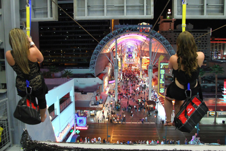 On the new SlotZilla, guests ride zip lines that swoop past the vintage casinos of downtown Las Vegas and under the giant video canopy of the Fremont Street Experience.