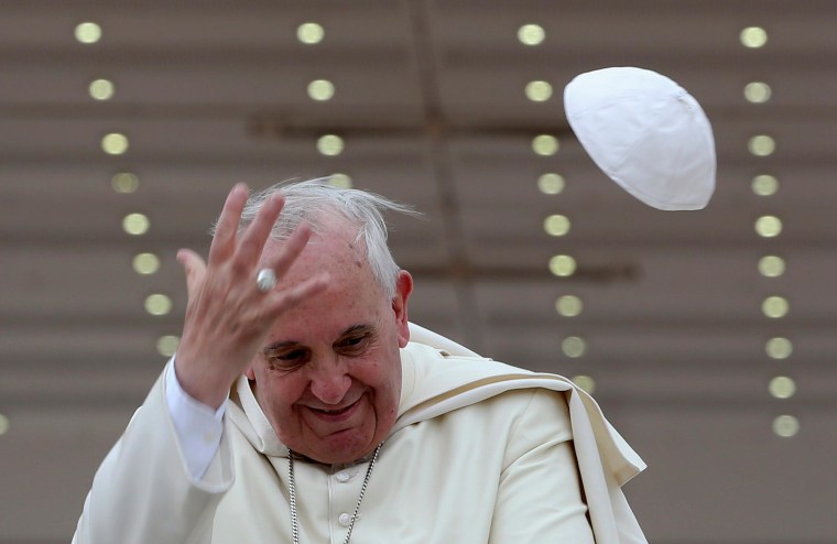 Image: A gust of wind blows off Pope Francis' cap during his weekly general audience at St. Peter's Square at the Vatican