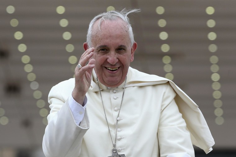 Image: Pope Francis waves as he leaves at the end of his weekly general audience at St. Peter's Square at the Vatican