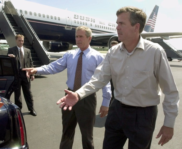 Image: Then-Republican presidential candidate George W. Bush, left, and his brother Florida Gov. Jeb Bush
