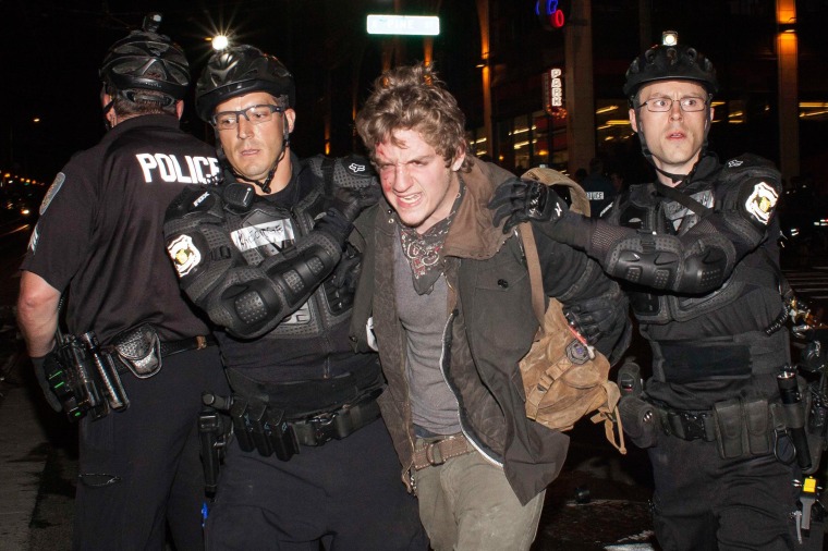 Image: Police detain a man during an anti-capitalist demonstration in Seattle, Washington