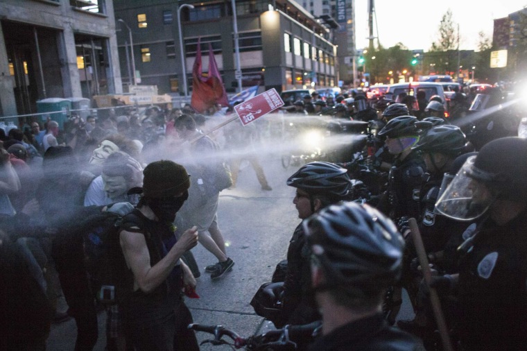 Image: Policemen target protestors with pepper spray during an anti-capitalist demonstration in Seattle, Washington