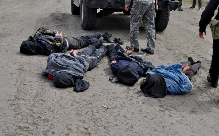 A photo released by Ukraine's Defense Ministry on Friday showed four people that it said were arrested near Slavyansk for allegedly shooting down helicopters.