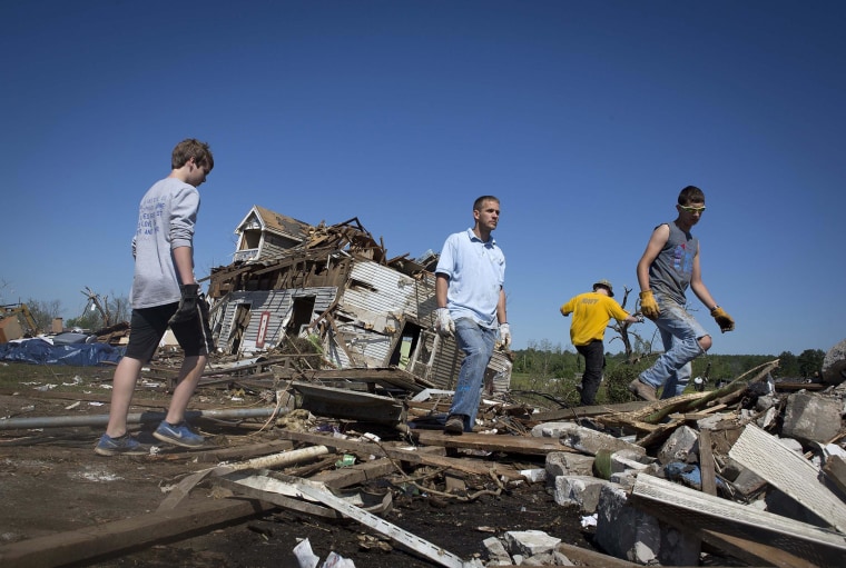 Image: Volunteers pick up debris as the clean up continues in Vilonia, Arkansas