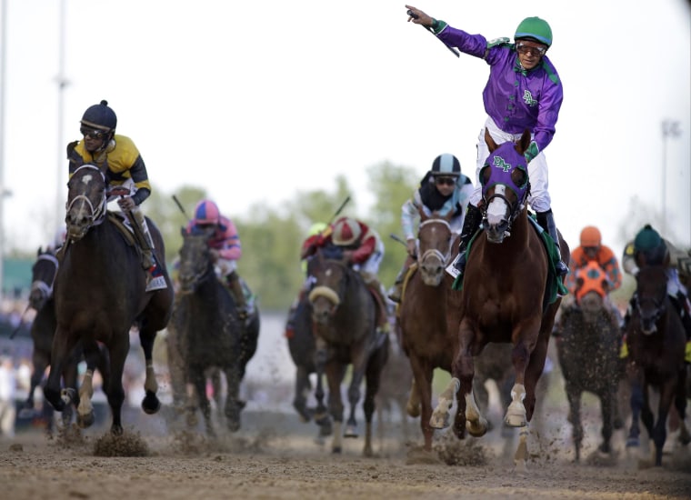 Image: Victor Espinoza rides California Chrome to a victory during the 140th running of the Kentucky Derby
