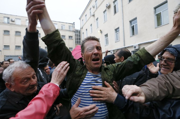 Image: Participants of a rally welcome a man who was just released from a city police department in Odessa