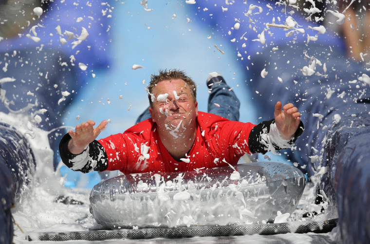 Image: A man slides down a giant water slide