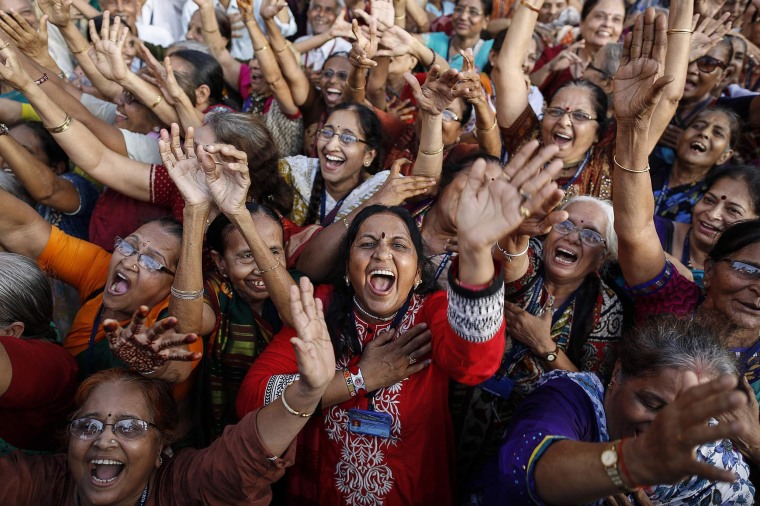 Image: Members of a laughter club participate in a laughing exercise in Mumbai